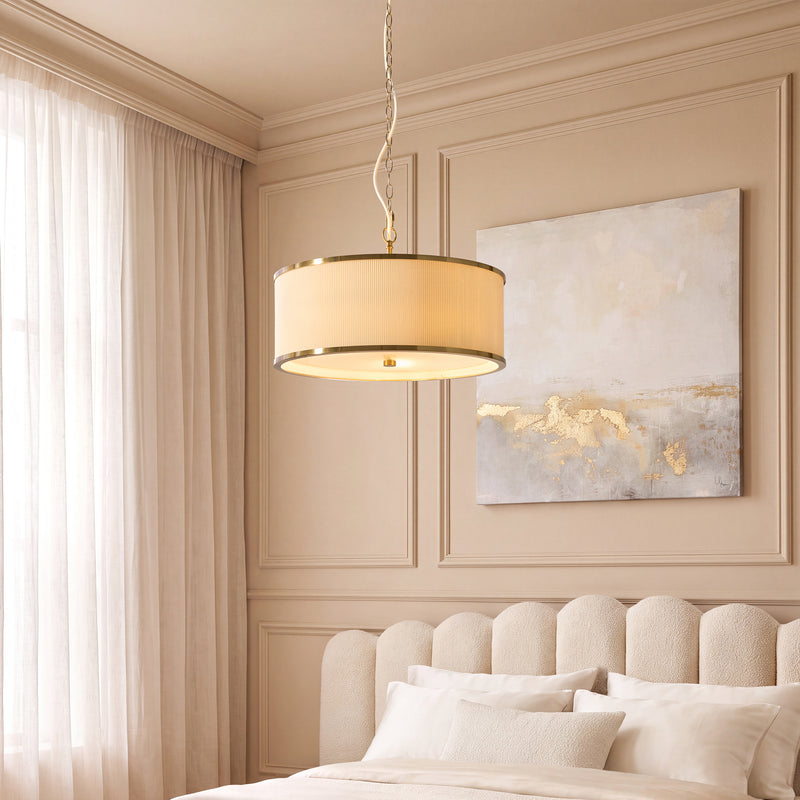 Lexi 3 Light Pendant in aged brass and ivory hanging in a bedroom