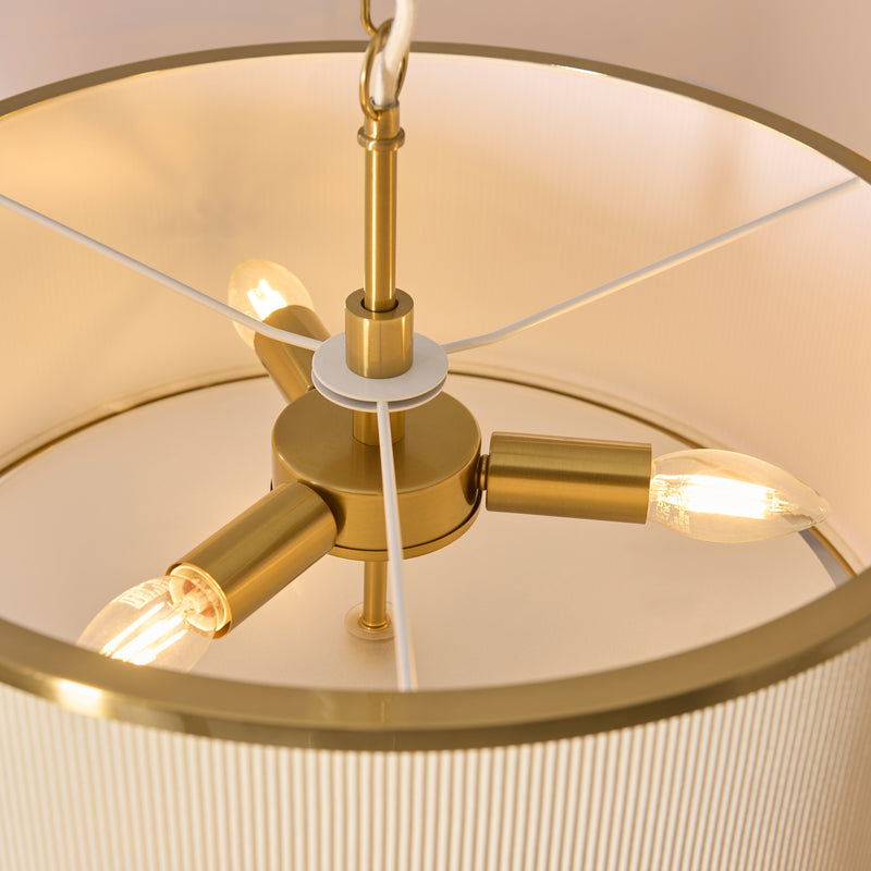 Detail of the aged brass and ivory finish on the Lexi 3 Light Pendant