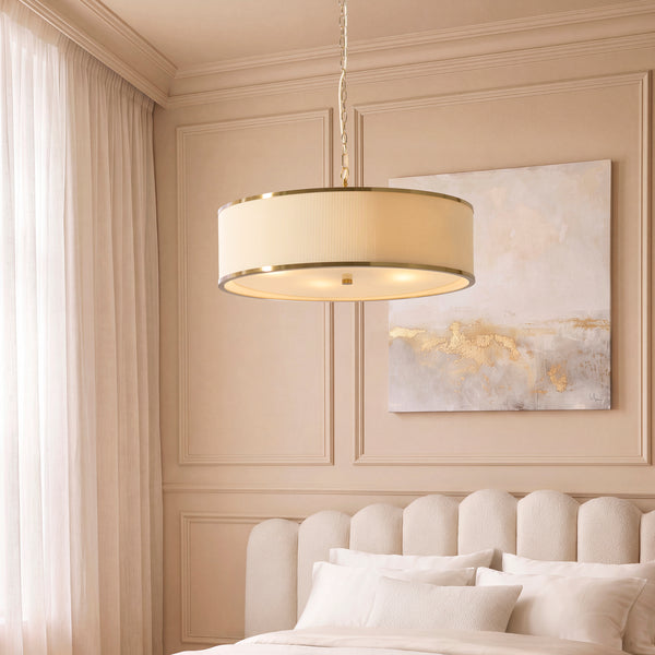 Lexi 5 Light Pendant in aged brass and ivory hanging in a living room