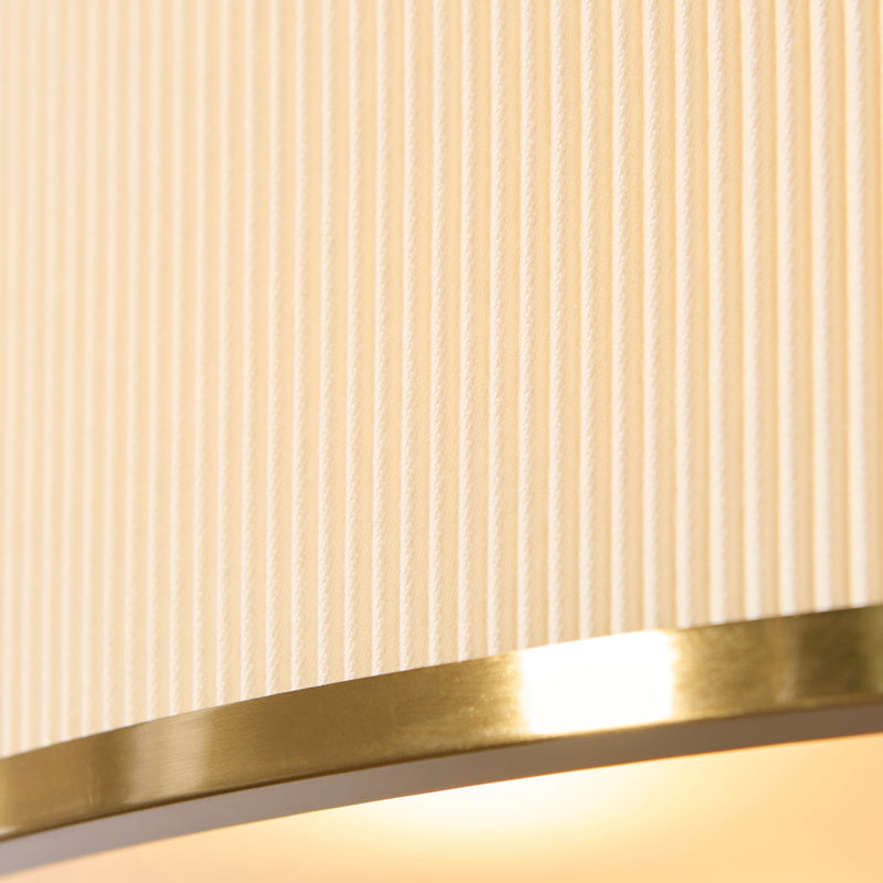 Detail of the aged brass and ivory finish on the Lexi 5 Light Pendant