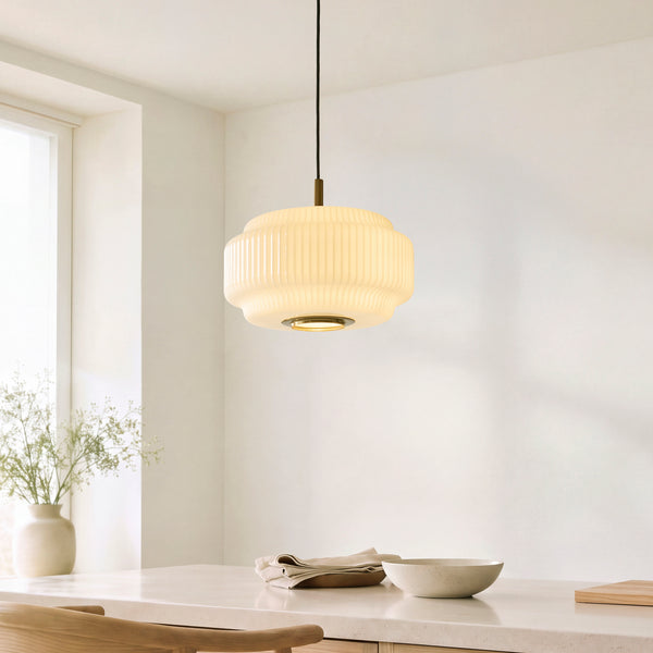 Evora Large Pendant in brushed aged brass hanging in a kitchen