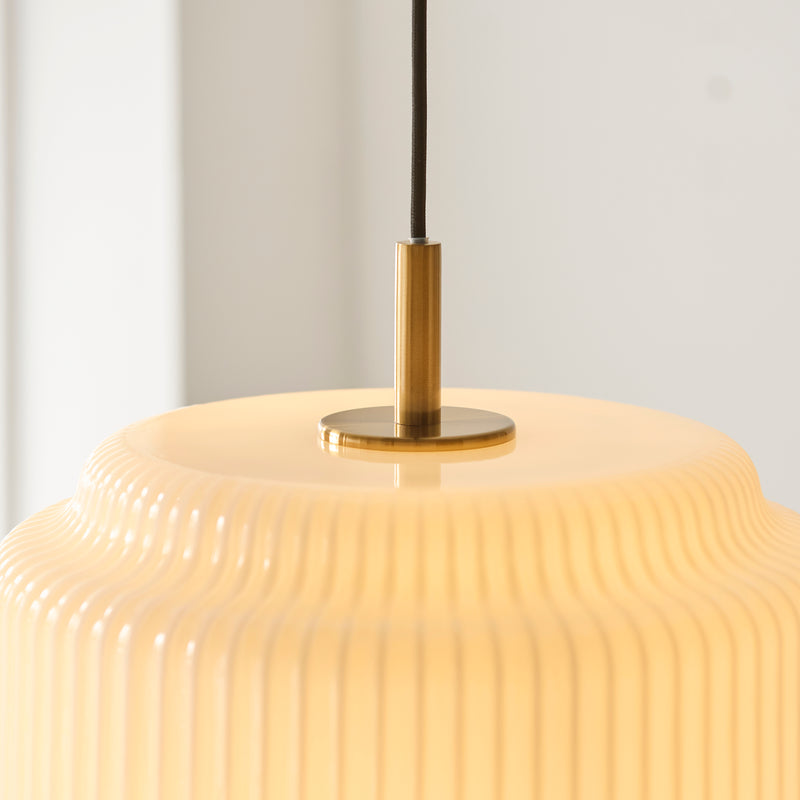 Evora Large Pendant in brushed aged brass shown in a room setting