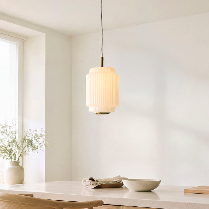 Evora Small Pendant in brushed aged brass hanging in a kitchen