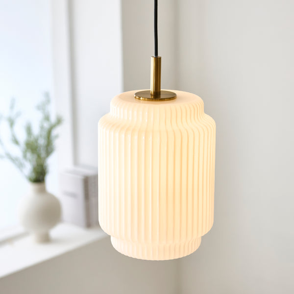Evora Small Pendant in brushed aged brass shown in a room setting