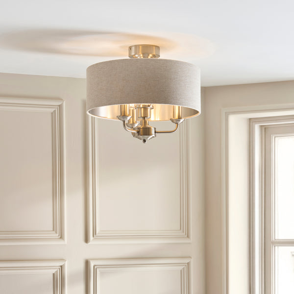 Highclere 3 Light Flush Ceiling Light lit up in a styled bedroom