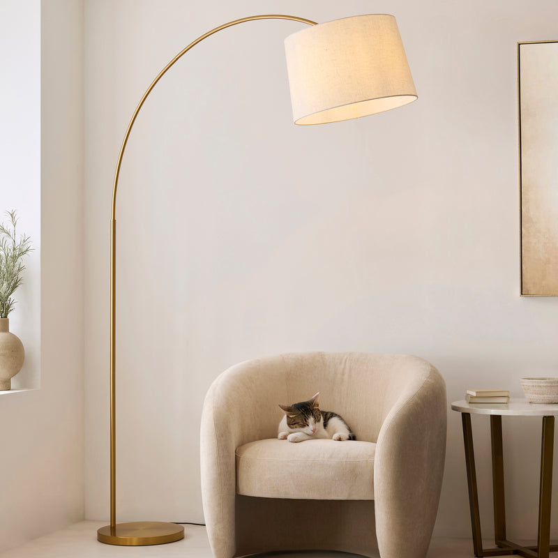 Endon Carlson XL Arc Floor Lamp in warm brass in a styled living room