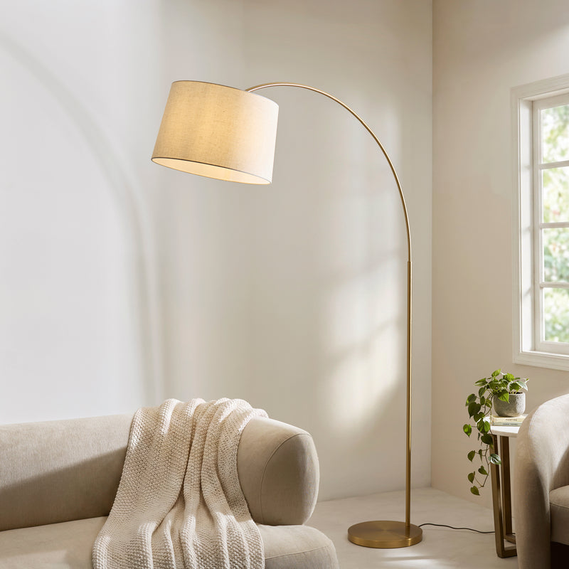 Carlson XL Arc Floor Lamp lit up in a living room setting