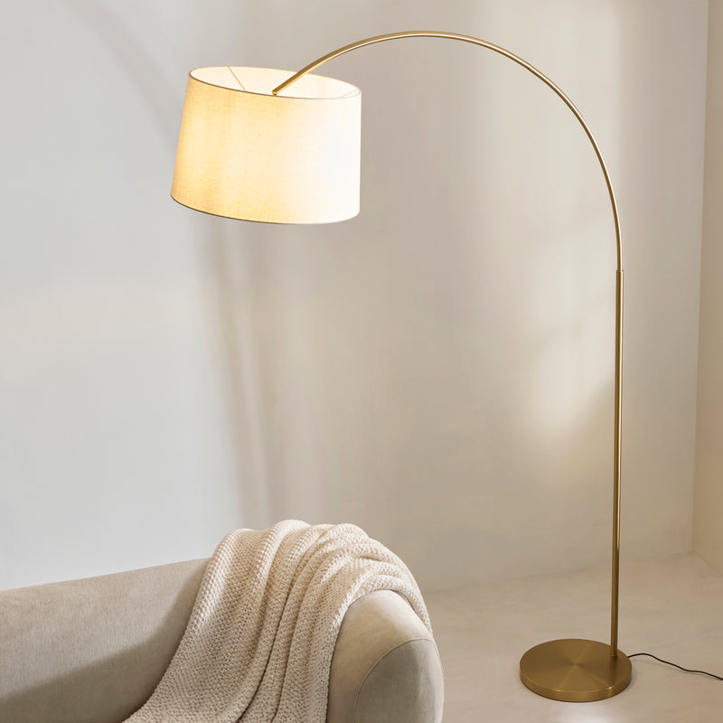 Carlson XL Arc Floor Lamp lit up in a living room setting