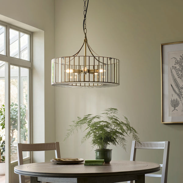 Antalya 5 Light Pendant in antique solid brass hanging in a dining room