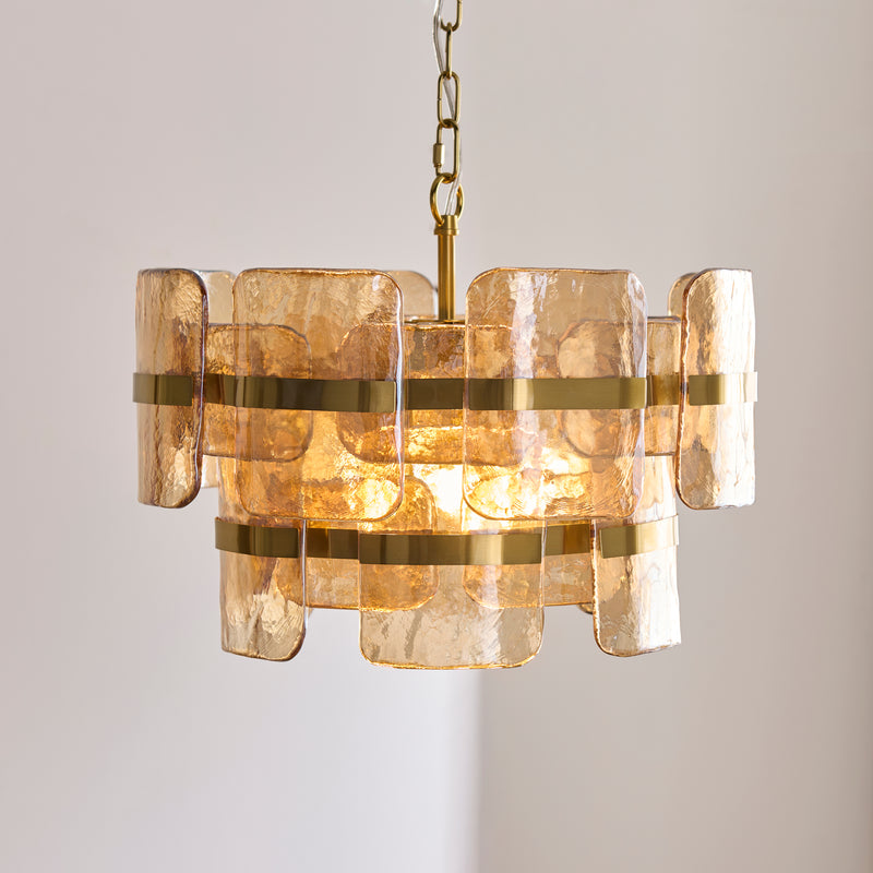 Ancara 3 Light Pendant lit up in a styled hallway