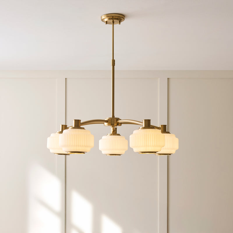 Evora 5 Light Pendant lit up in a styled living room