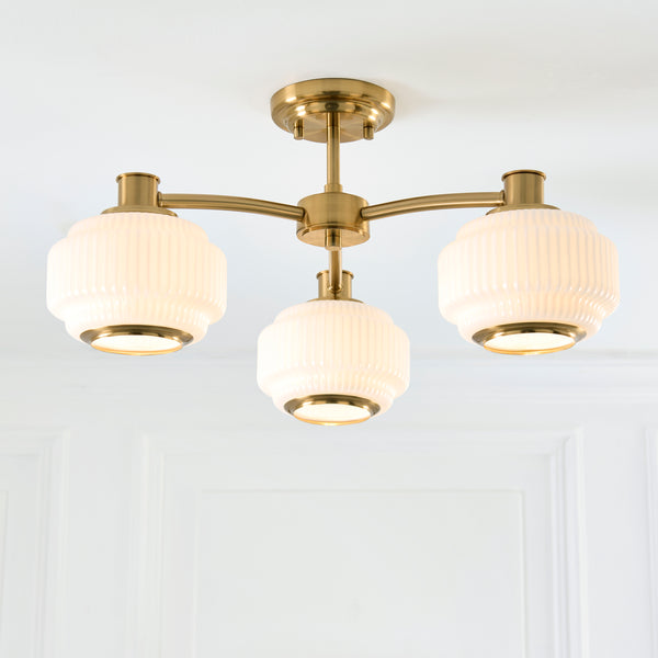 Evora 3 Light Semi Flush Ceiling Light lit up in a styled bedroom