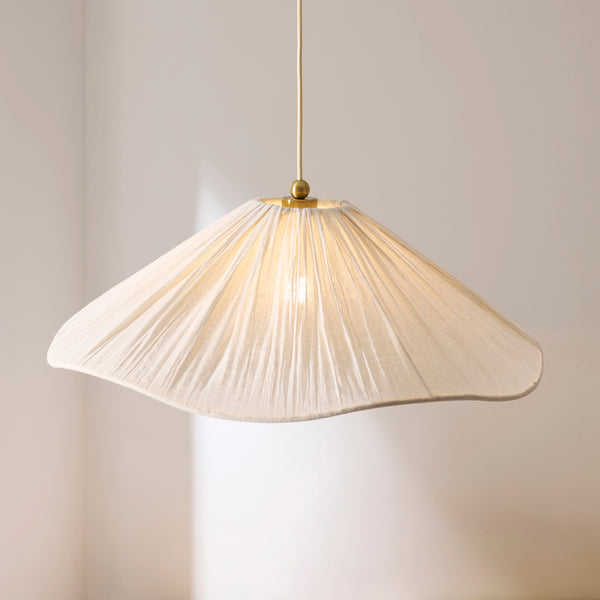 Isabella Grand Pendant lit up in a styled living room