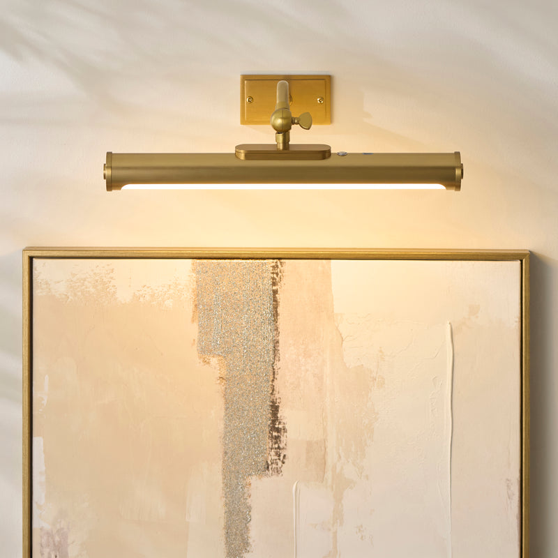 Maris Rechargeable Picture Light in warm brass on a wall