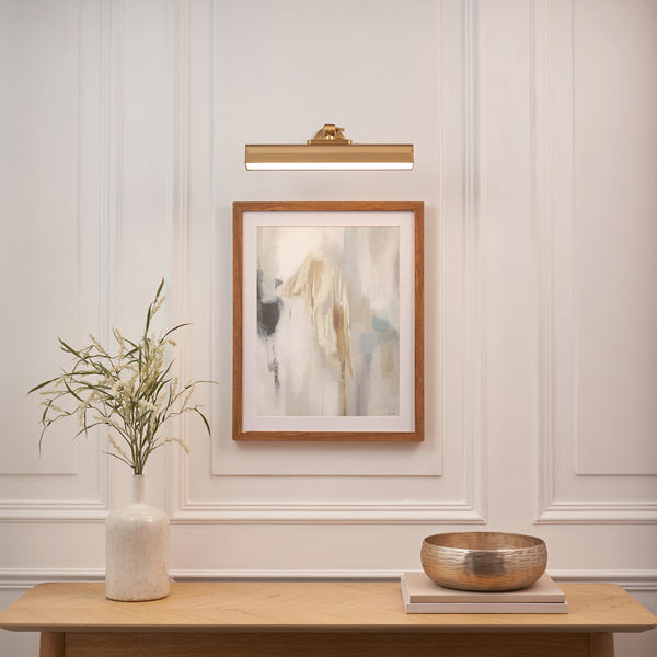 Dalyan Rechargeable Picture Light in warm brass on a wall