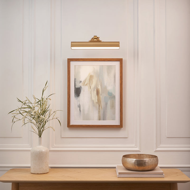 Dalyan Rechargeable Picture Light in warm brass on a wall