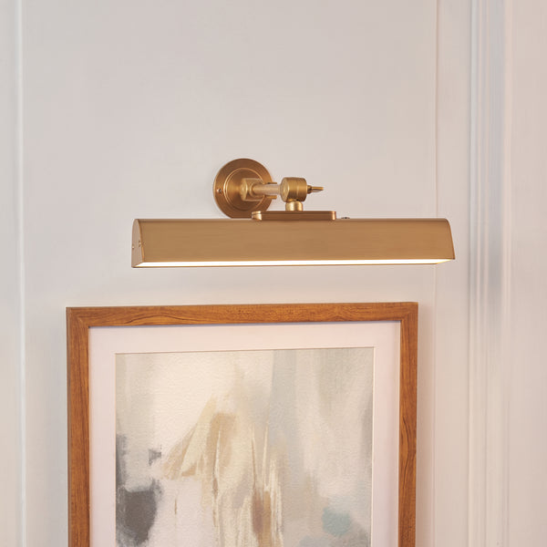 Dalyan Rechargeable Picture Light in warm brass shown in a room setting