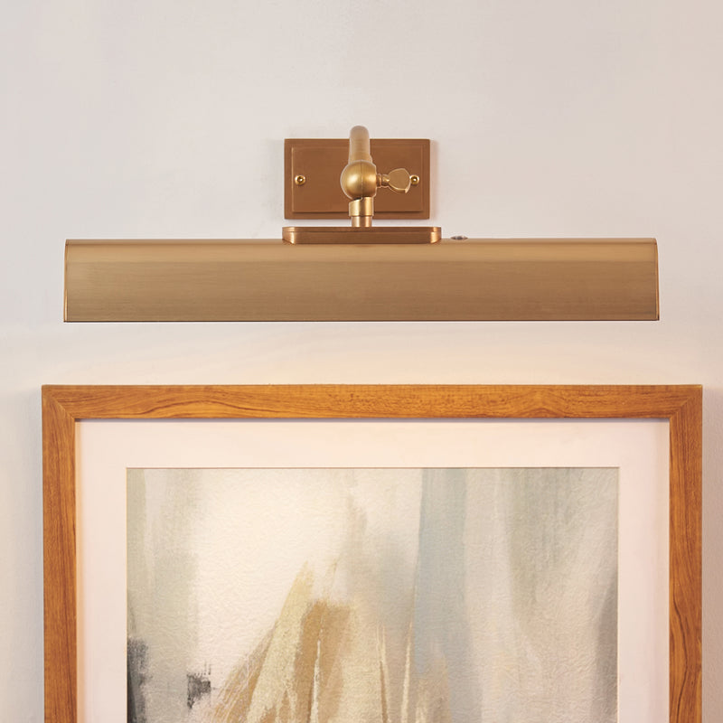 Lasos Rechargeable Picture Light in warm brass shown in a room setting