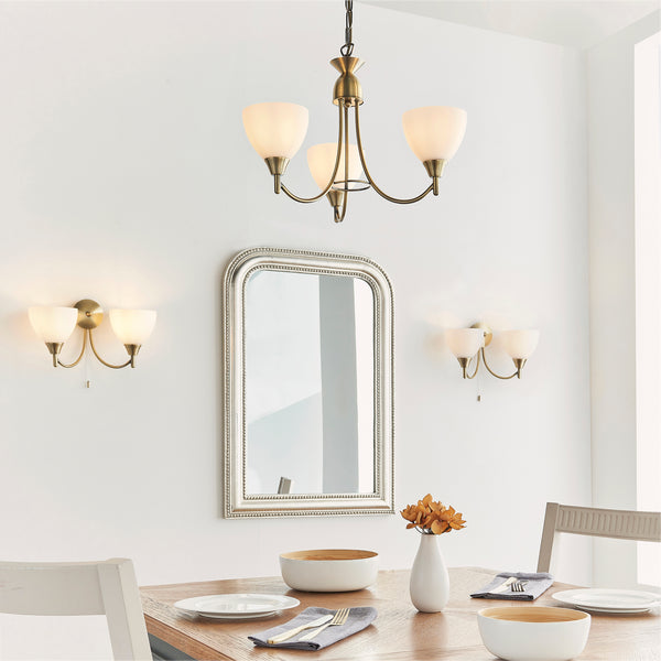 Alton 3 Light Pendant lit up in a styled bedroom