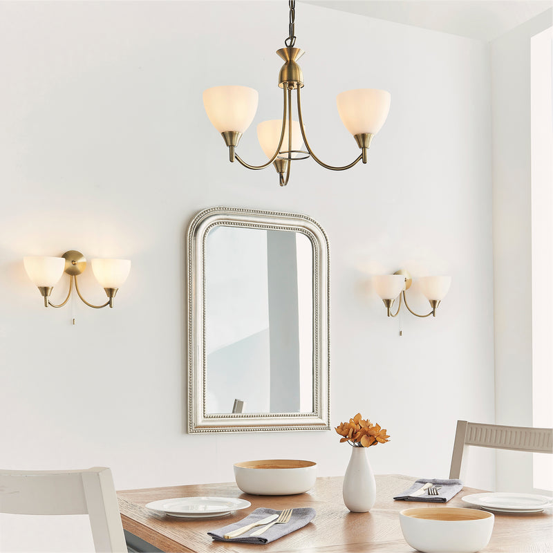 Alton 3 Light Pendant lit up in a styled bedroom