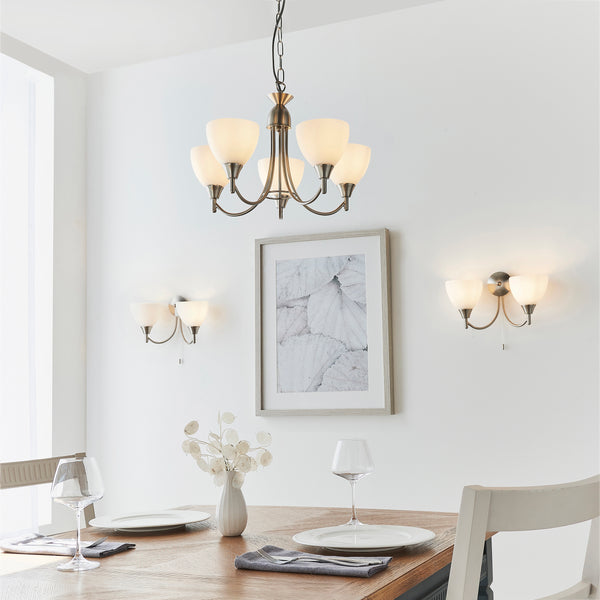 Alton 5 Light Pendant in satin chrome hanging in a living room