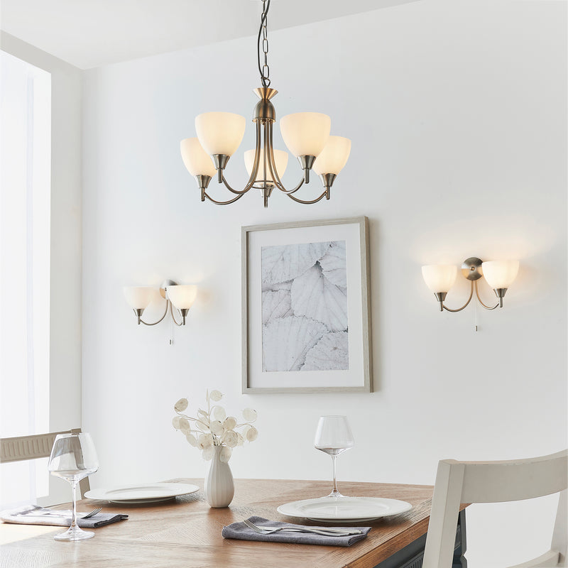 Alton 5 Light Pendant in satin chrome hanging in a living room