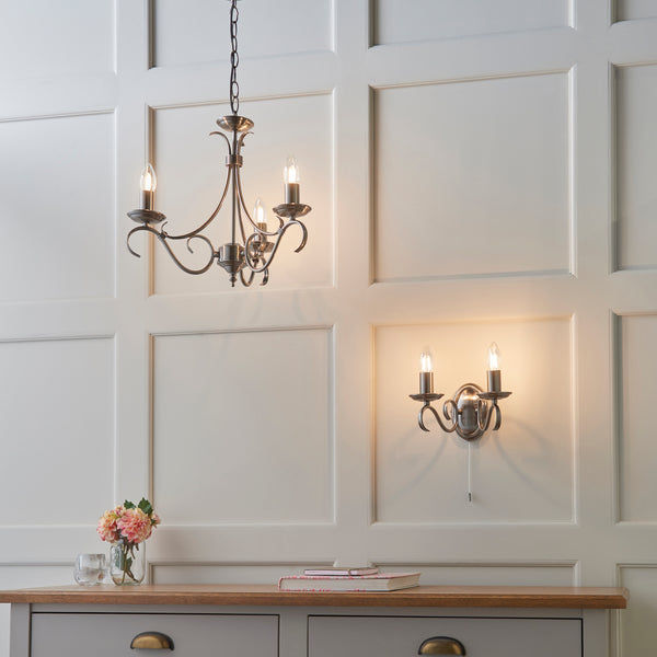 Bernice 3 Light Chandelier lit up in a styled bedroom