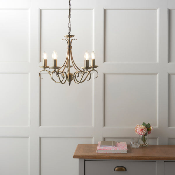 Bernice 5 Light Chandelier lit up in a styled living room