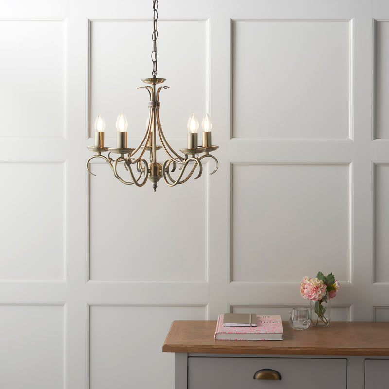 Bernice 5 Light Chandelier lit up in a styled living room