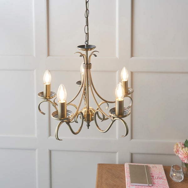 Bernice 5 Light Chandelier in antique brass shown in a room setting