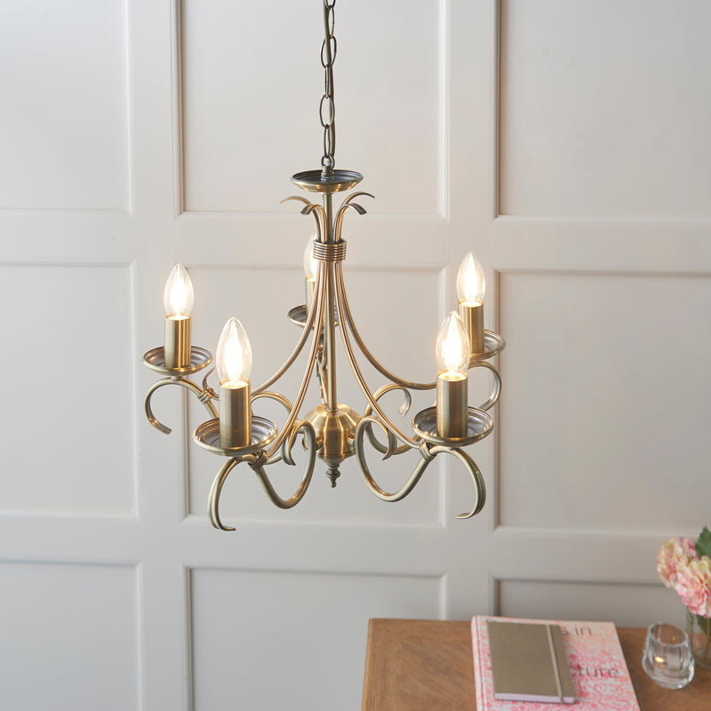 Bernice 5 Light Chandelier in antique brass shown in a room setting