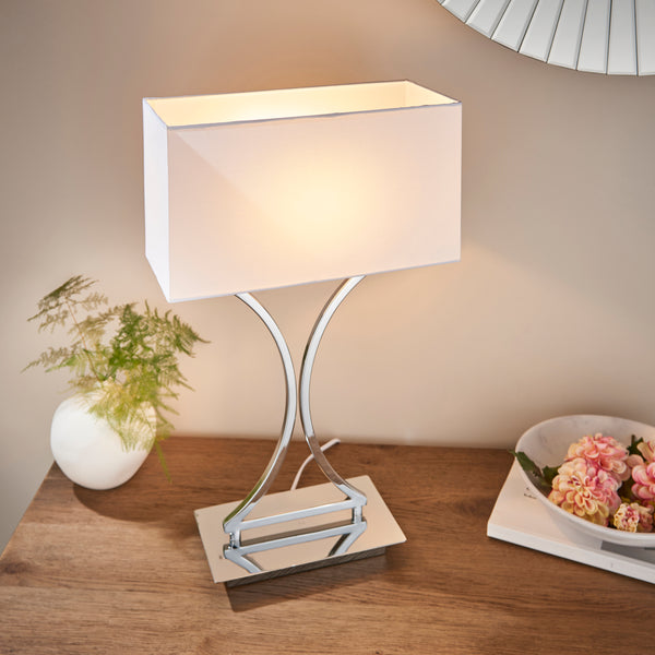 Epalle Table Lamp lit up in a bedroom setting