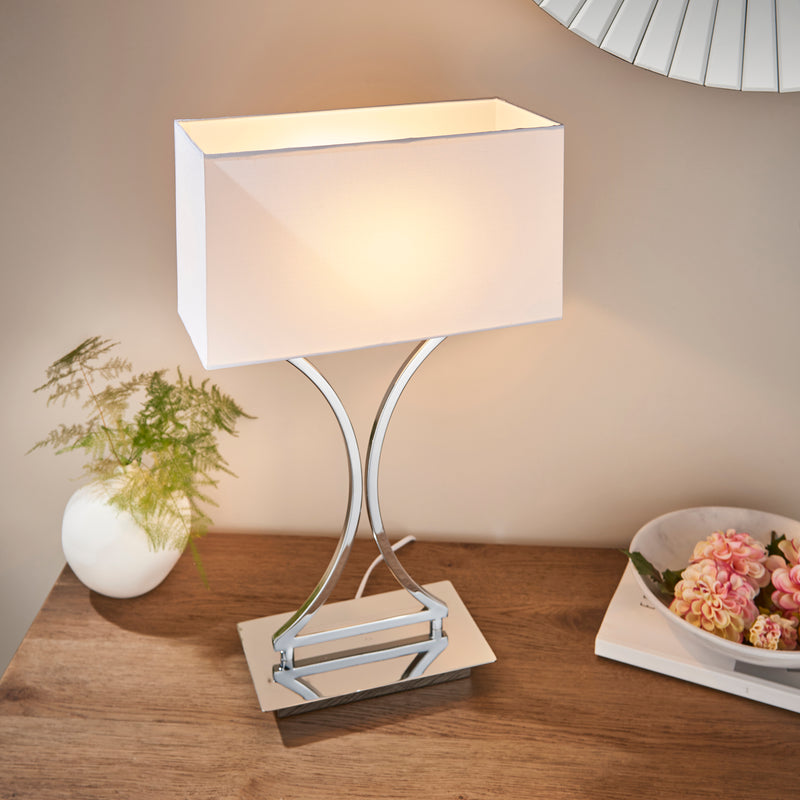 Epalle Table Lamp lit up in a bedroom setting