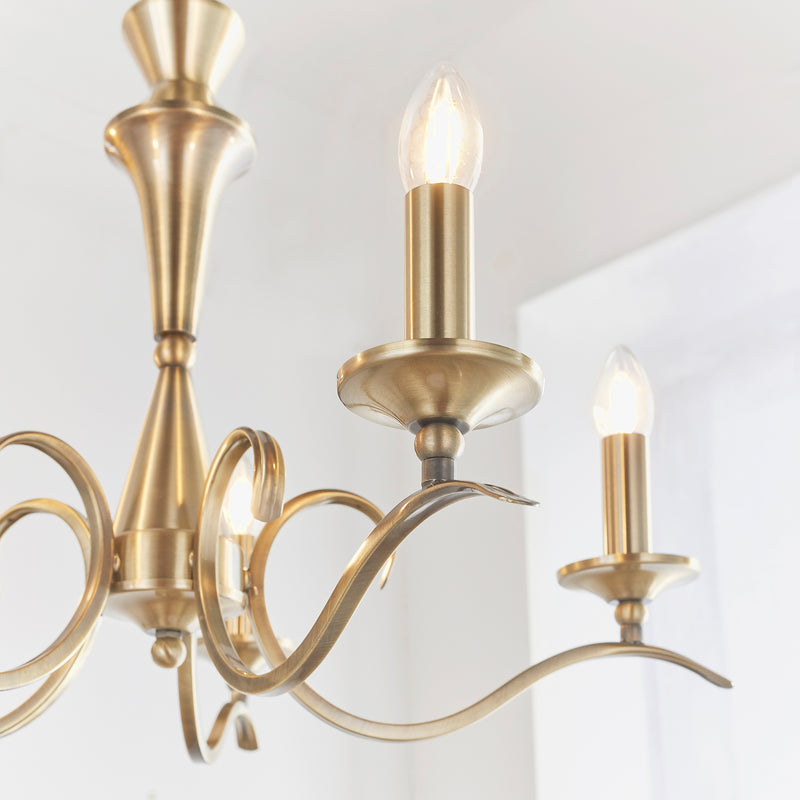 Kora 5 Light Chandelier lit up in a styled living room