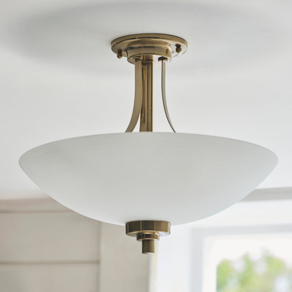 Welles 3 Light Semi Flush Ceiling Light lit up in a styled bedroom