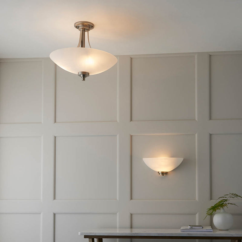 Welles 3 Light Semi Flush Ceiling Light lit up in a styled bedroom