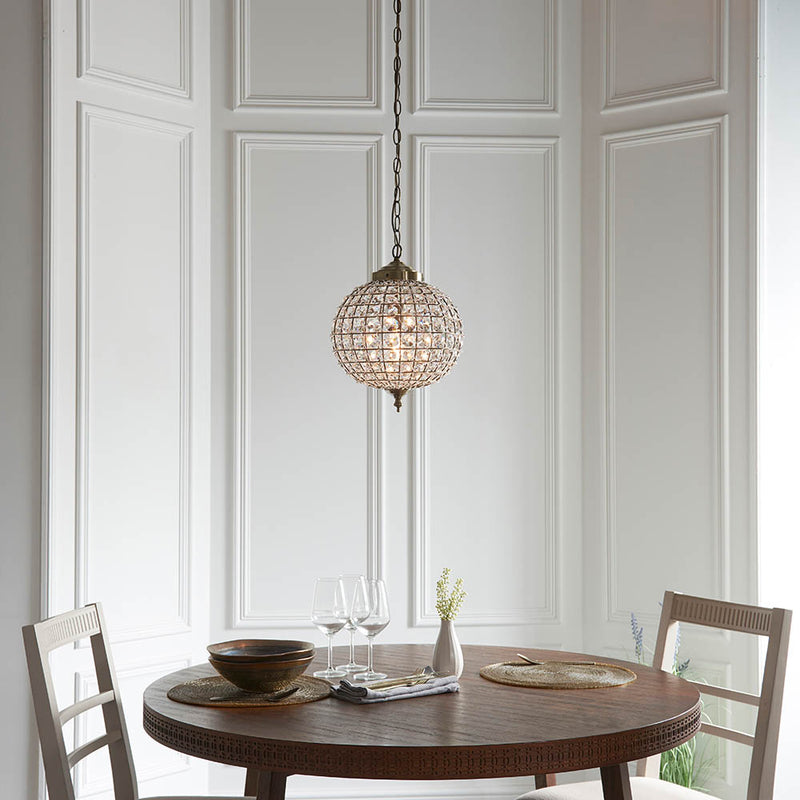 Tanaro Pendant in antique brass shown in a room setting