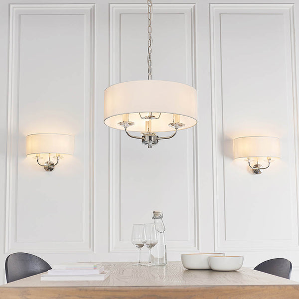 Nixon 3 Light Chandelier lit up in a styled bedroom