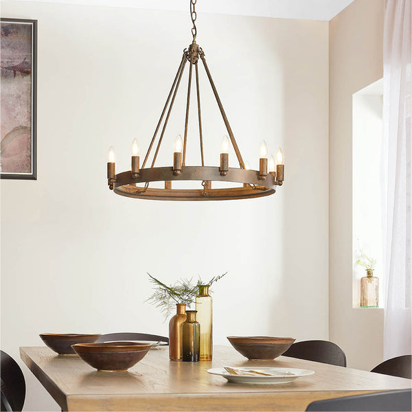Chevalier 12 Light Candle Chandelier in aged metal hanging in a dining room