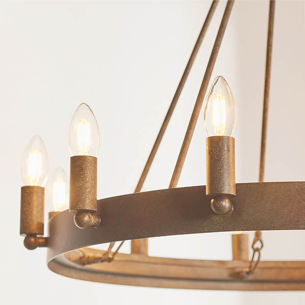 Chevalier 12 Light Candle Chandelier lit up in a styled dining room
