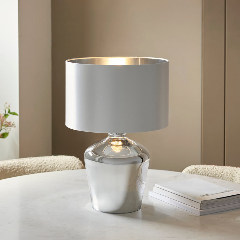 Waldorf Glass Table Lamp lit up in a living room setting