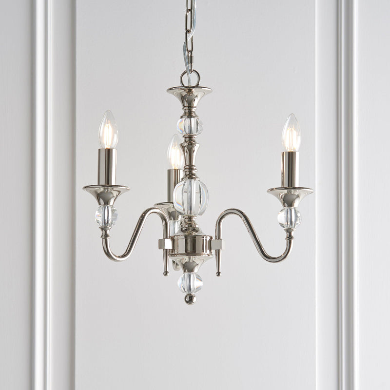 Interiors 1900 Polina 3-Light Chandelier in Polished Nickel – A classic chandelier with a polished nickel frame, clear crystal accents, and elegant detailing. Designed with three lights, adjustable height, and dimmable functionality, it’s ideal for traditional and contemporary interiors. Uses 3 x E14 bulbs (not included).