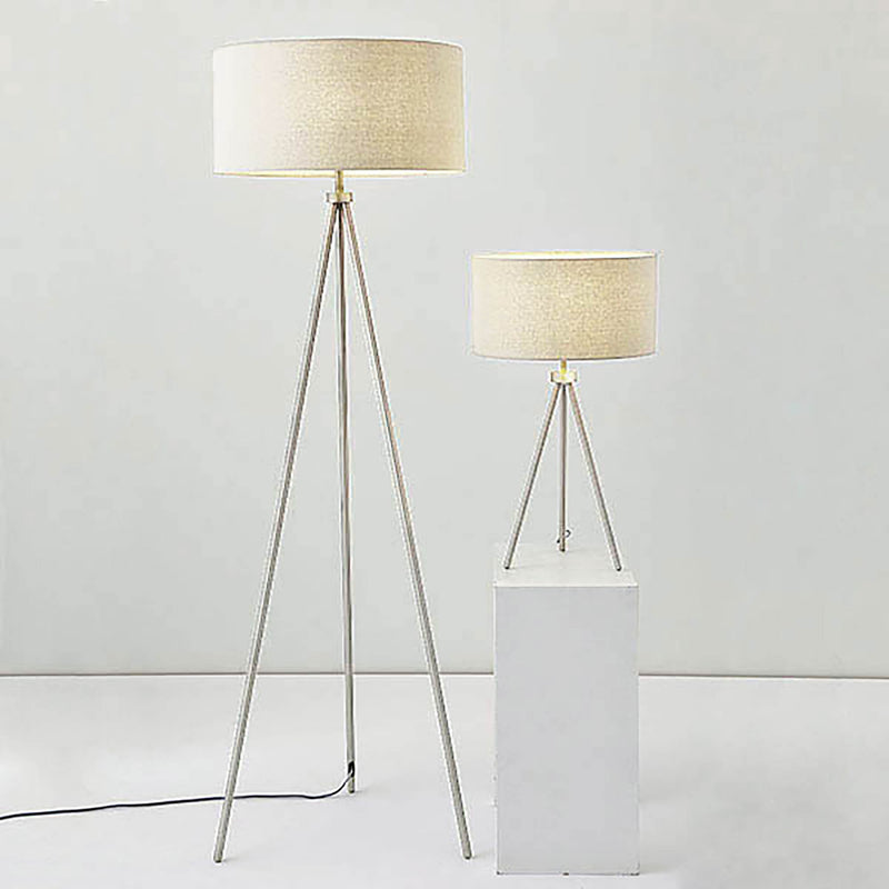Tri Tripod Floor Lamp lit up in a living room setting