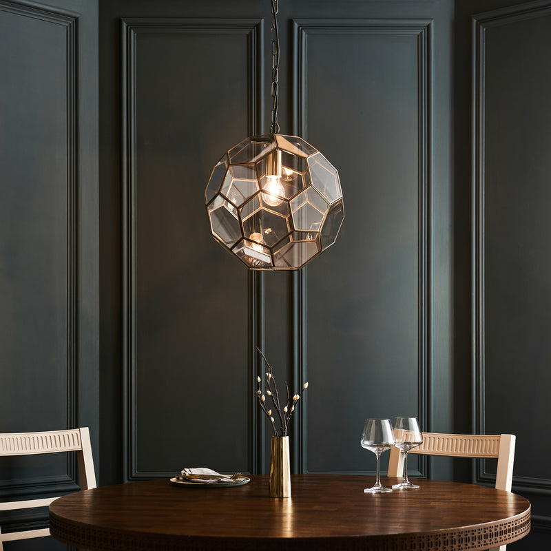 Miele Pendant in antique brass hanging in a hallway