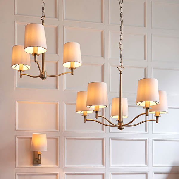 Ortona 5 Light Chandelier in matt antique brass hanging in a living room