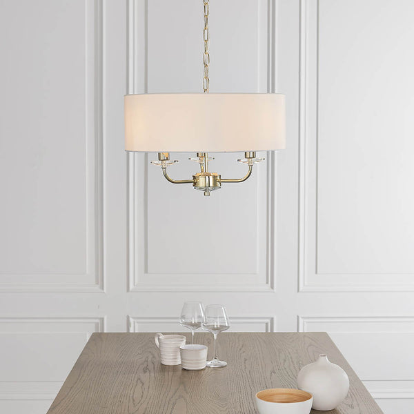 Nixon 3 Light Chandelier lit up in a styled bedroom