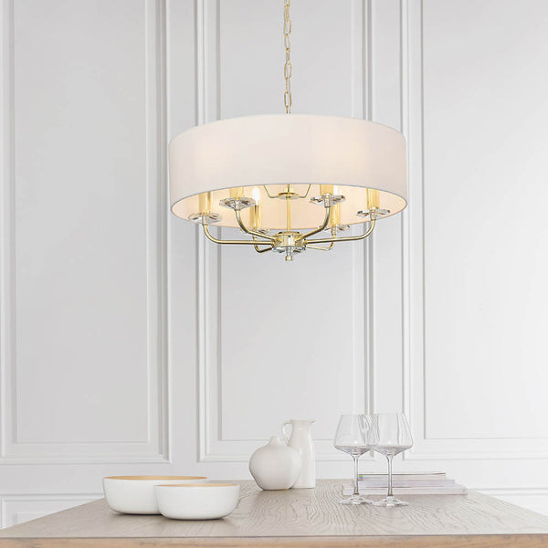 Nixon 6 Light Chandelier lit up in a styled living room