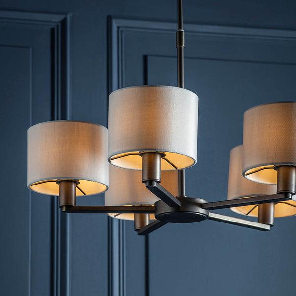 Daley 5 Light Pendant lit up in a styled living room