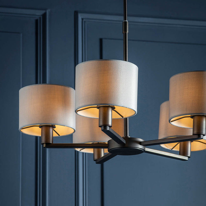 Daley 5 Light Pendant lit up in a styled living room
