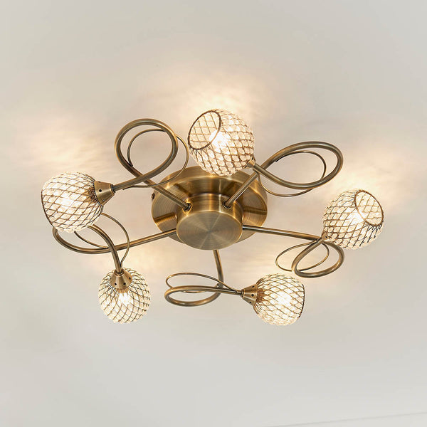 Aherne 5 Light Flush Ceiling Light in antique brass on a living room ceiling